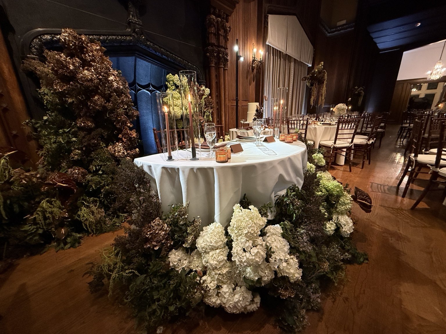 Wedding reception tables with floral arrangements and candles